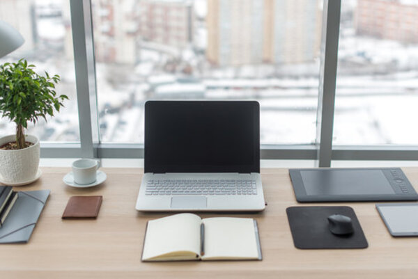 A tidy desk with a notebook and calm natural light